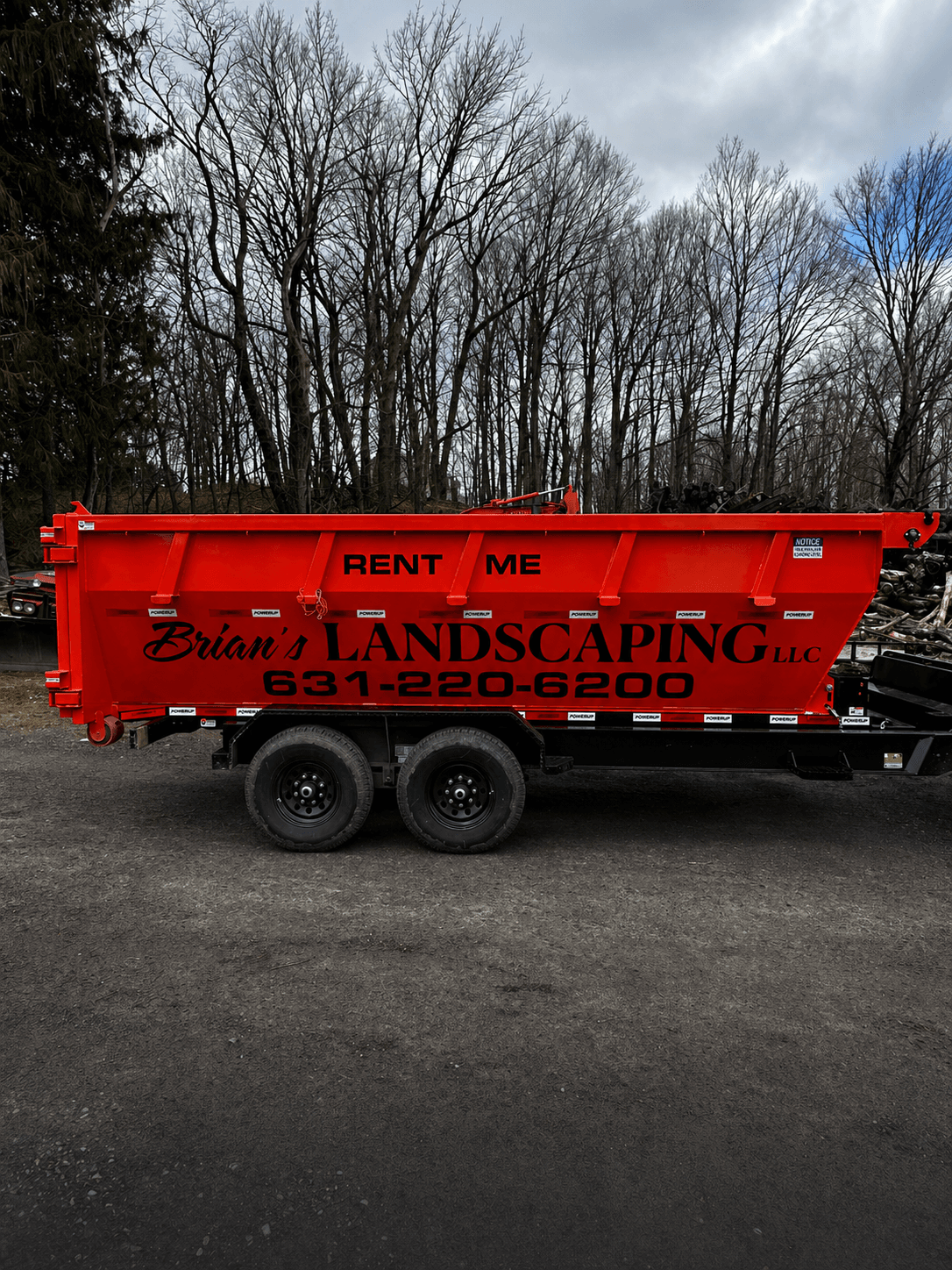 Brian's Landscaping branded red dumpster on a trailer